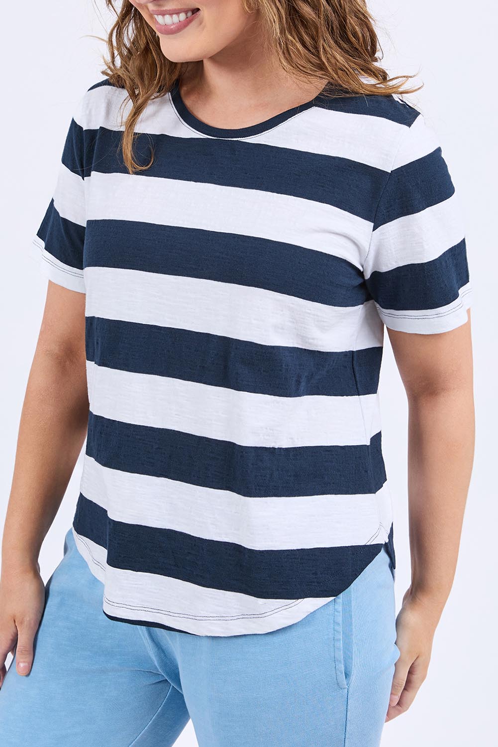 A model wearing the Fundamental Spritz Stripe Ss Cotton Tee in colour Navywhite (Blue), from the front, cropped image