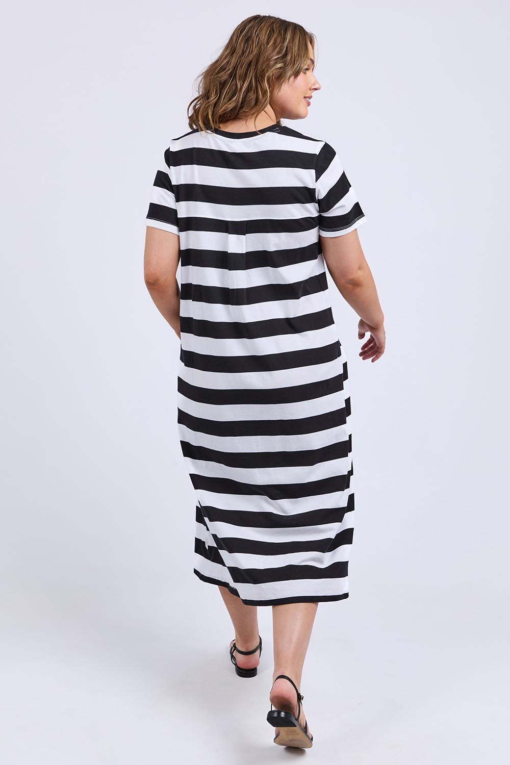 A model wearing the Fundamental Adira Cotton Dress in colour Blackwhite (Black), from the back