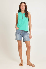 Model Madeline wearing size 10 of the Fundamental Elysian Cotton Tank in colour Gumdrop (Green), from the front, showing the whole outfit