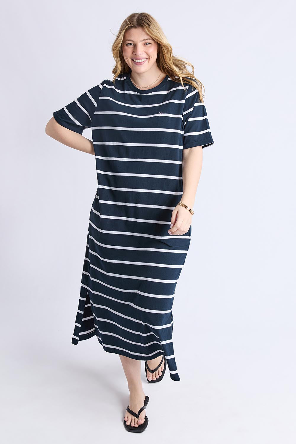 A model wearing the Fundamental Halli Cotton Tee Dress in colour Navywhite (Blue), from the front, showing the whole outfit