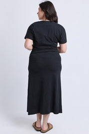 A model wearing the Fundamental Colette Cotton Dress in colour Black (Black), from the back