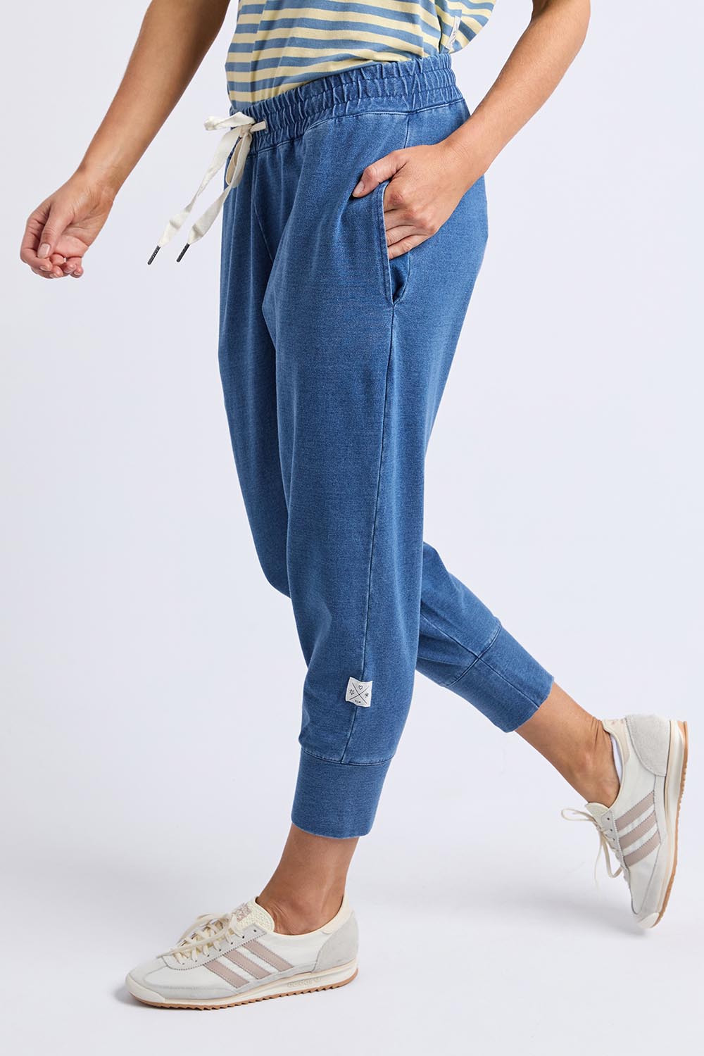 A model wearing the Fundamental Brunch Denim Look Pant in colour Bluedenim (Blue), from the front, cropped image