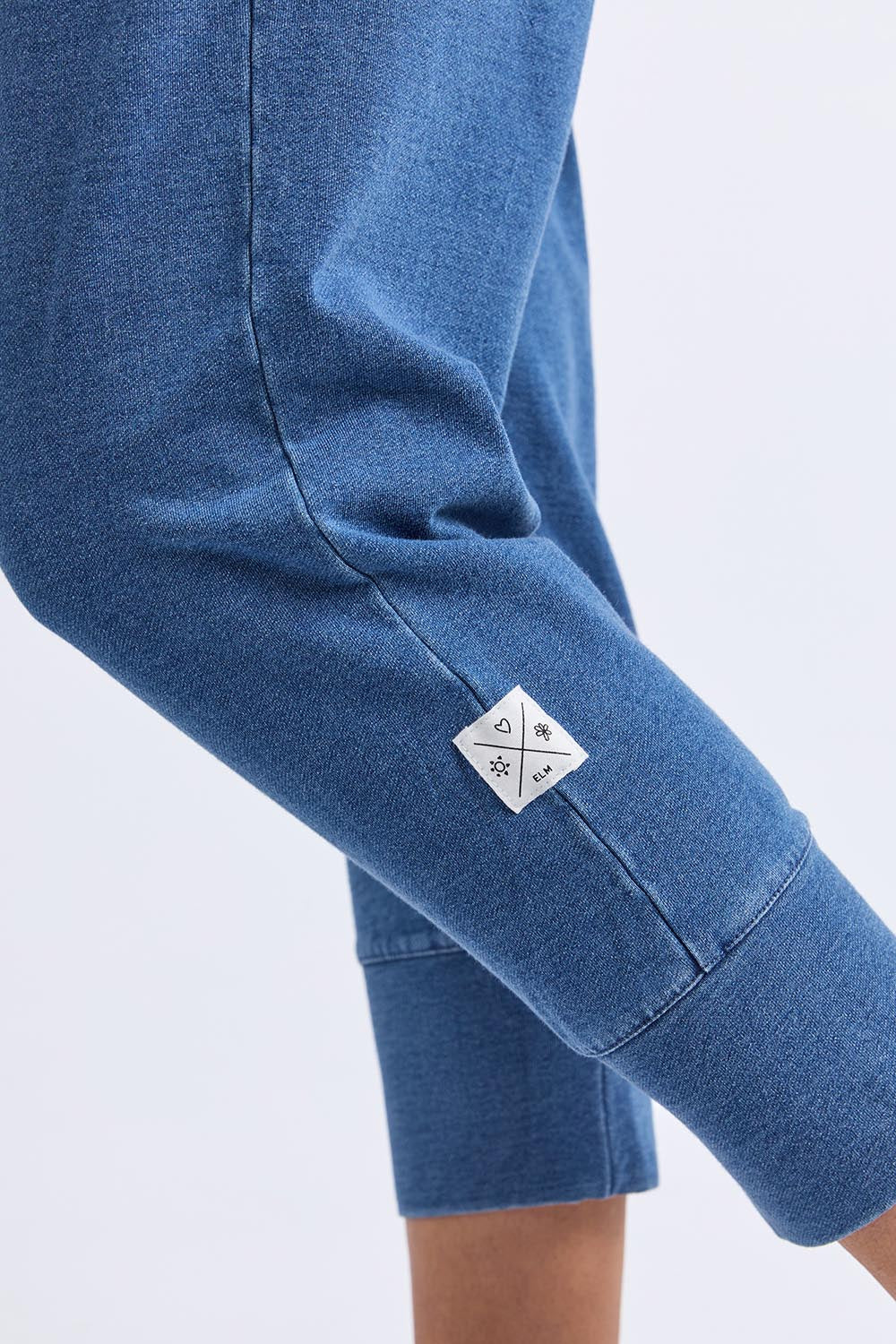 A model wearing the Fundamental Brunch Denim Look Pant in colour Bluedenim (Blue), from the front, cropped image