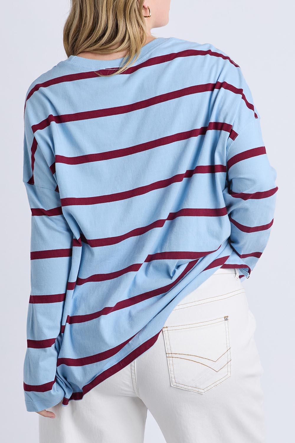 A model wearing the Fundamental Calli Stripe Cotton Long Sleeve Tee in colour Blueplum (Blue), from the back
