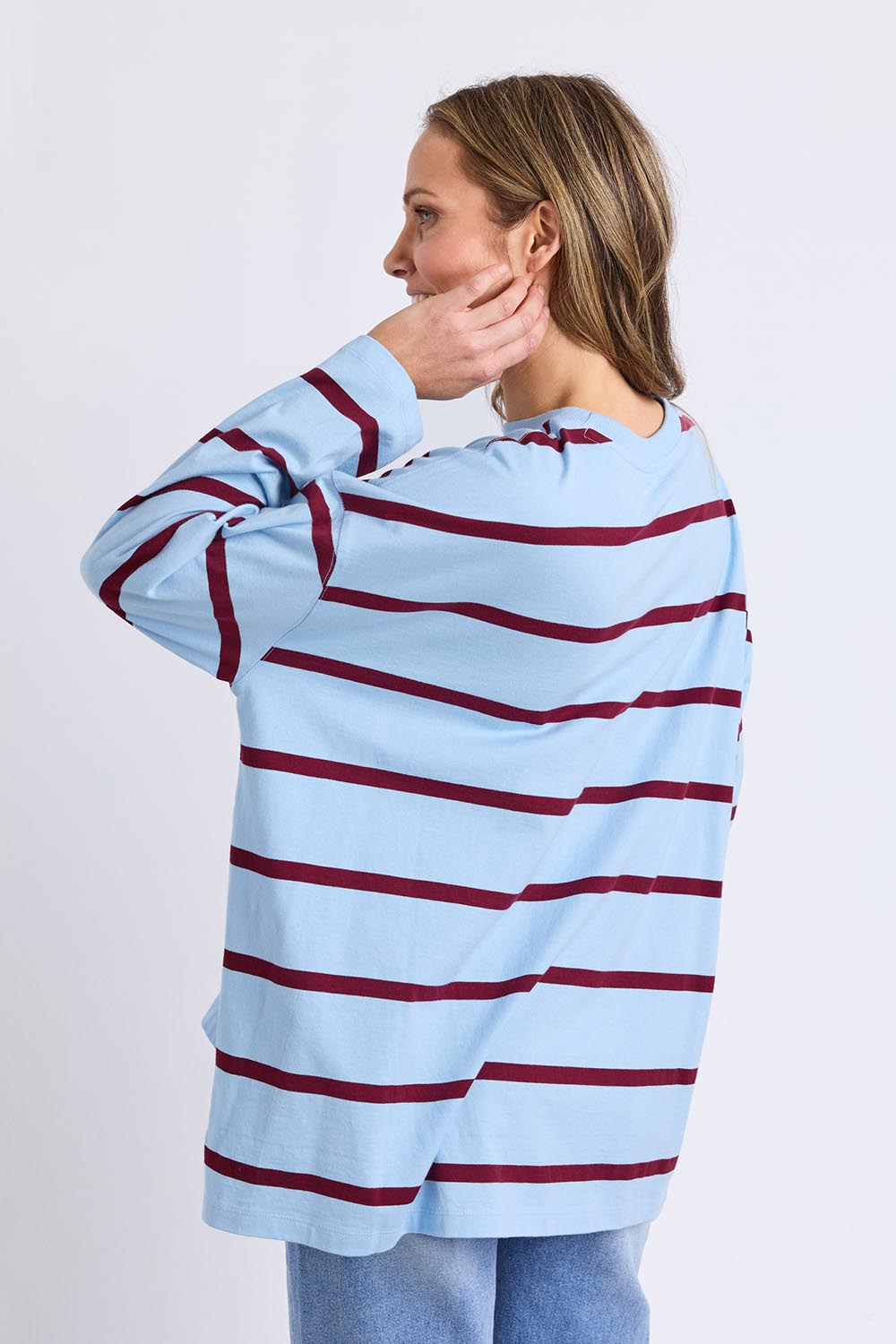 A model wearing the Fundamental Calli Stripe Cotton Long Sleeve Tee in colour Blueplum (Blue), from the back