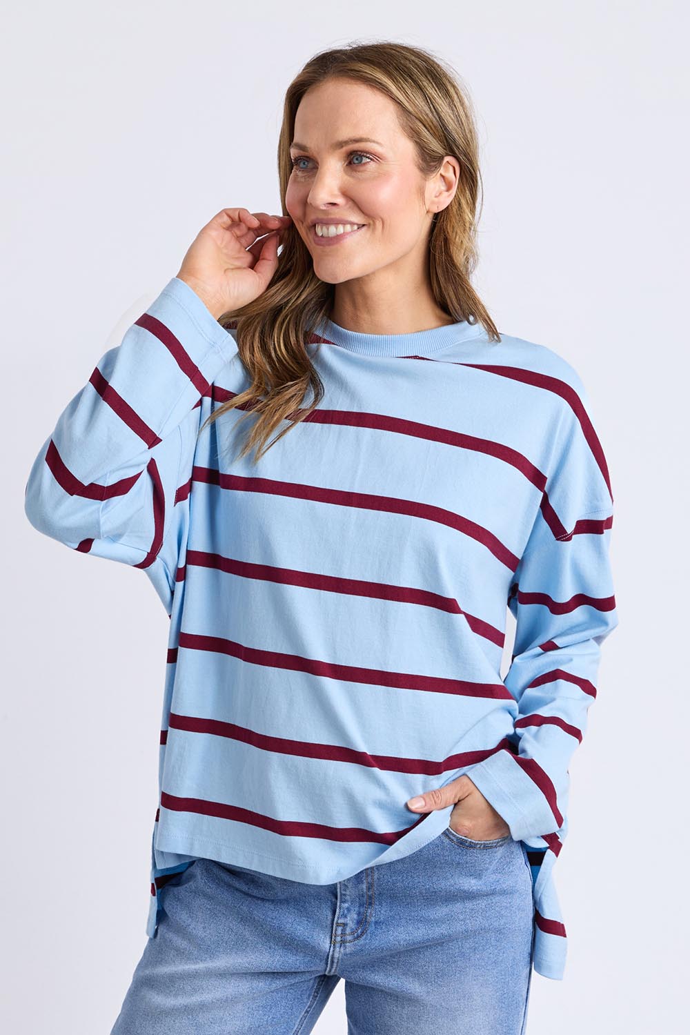 A model wearing the Fundamental Calli Stripe Cotton Long Sleeve Tee in colour Blueplum (Blue), from the front, cropped image