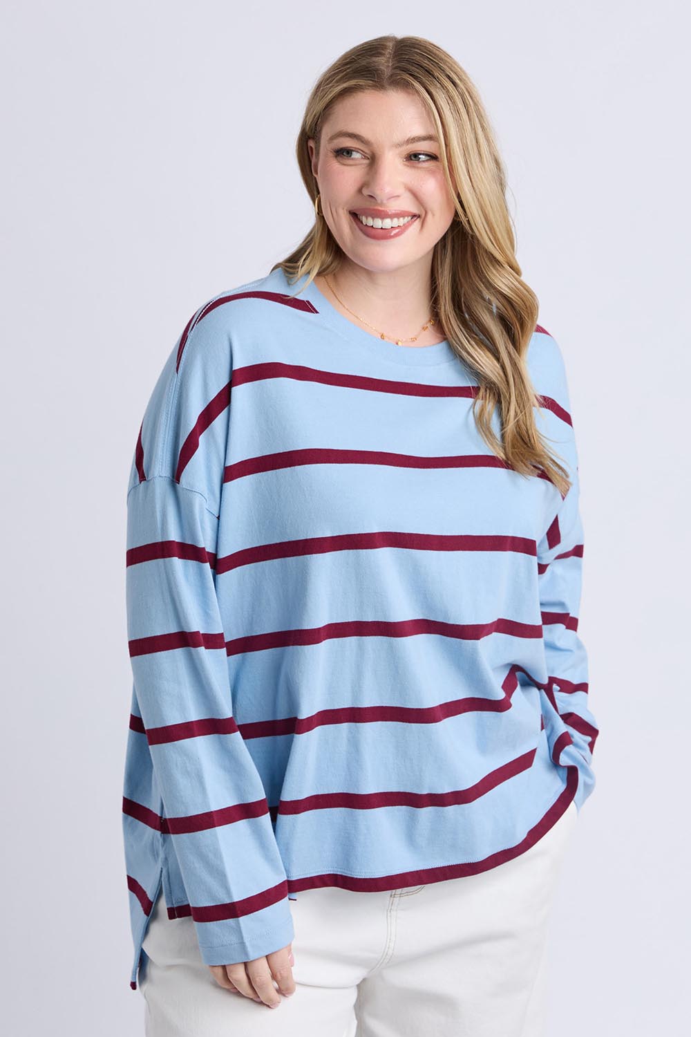 A model wearing the Fundamental Calli Stripe Cotton Long Sleeve Tee in colour Blueplum (Blue), from the front, cropped image