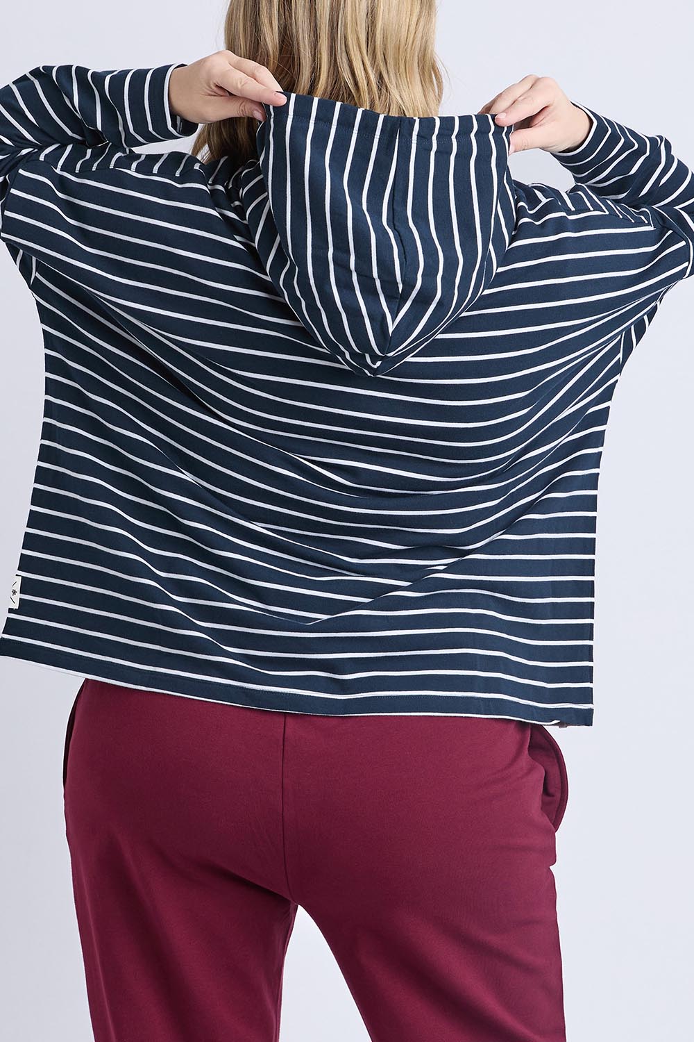 A model wearing the Fundamental Rhea Stripe Cotton Hoodie in colour Navystripe (Blue), from the back
