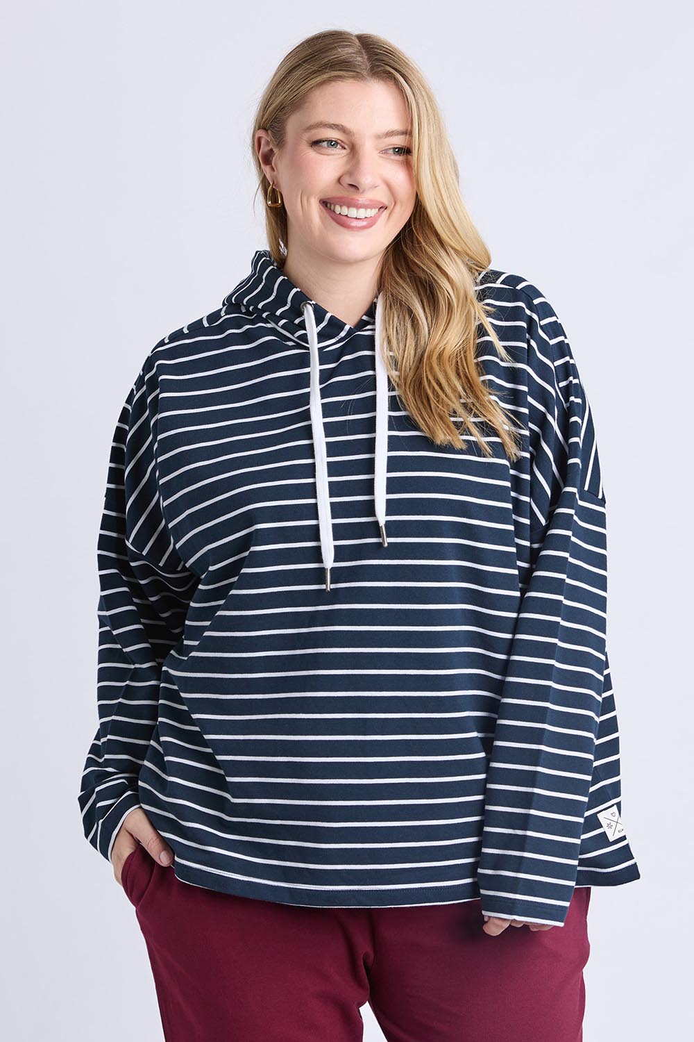 A model wearing the Fundamental Rhea Stripe Cotton Hoodie in colour Navystripe (Blue), from the front, cropped image