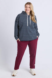 A model wearing the Fundamental Rhea Stripe Cotton Hoodie in colour Navystripe (Blue), from the front, showing the whole outfit