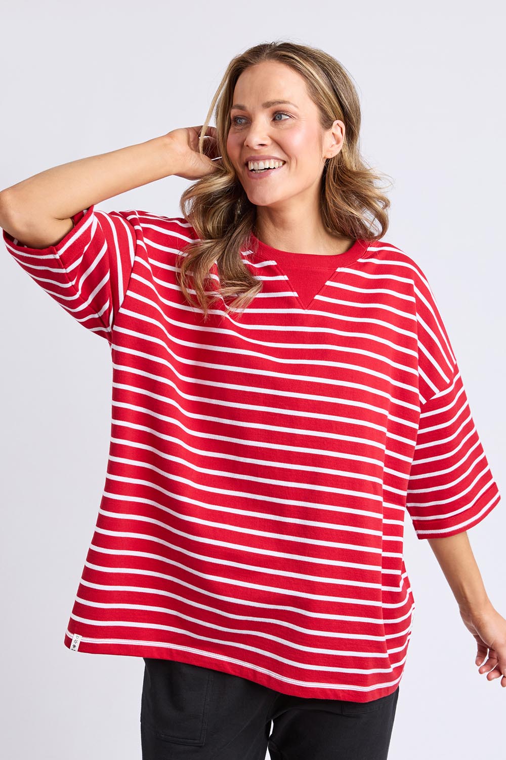 A model wearing the Fundamental Valentina Sweat in colour Cranbwhit (Red), from the front, cropped image