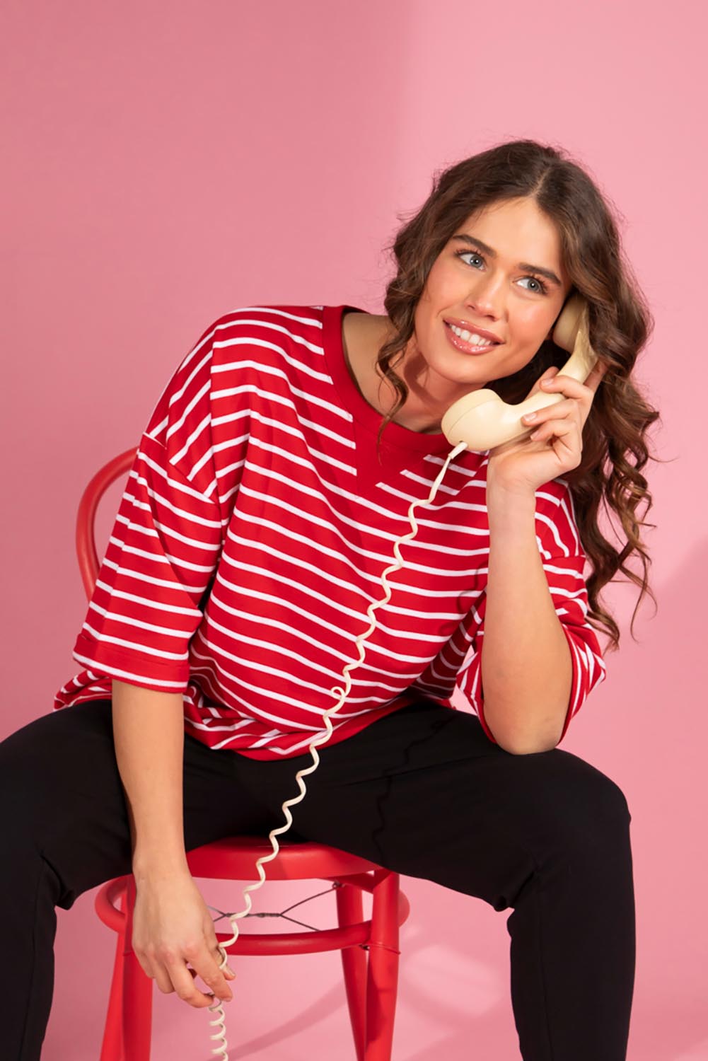 A model wearing the Fundamental Valentina Sweat in colour Cranbwhit (Red), from the front, showing the whole outfit