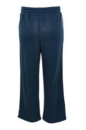 Product shot of the Fundamental Amara Trackpant in colour Navystripe (Blue), from the back