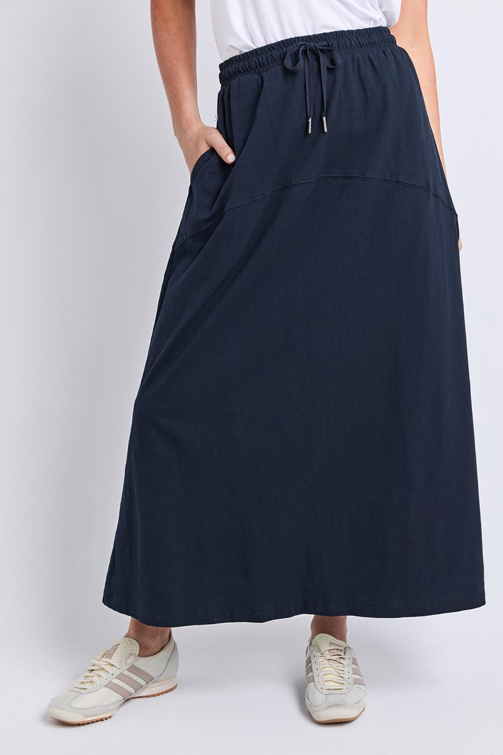 Model Genericm wearing size sample of the Fundamental Meadow Cotton Skirt – Navy in colour Navy, in a cropped view