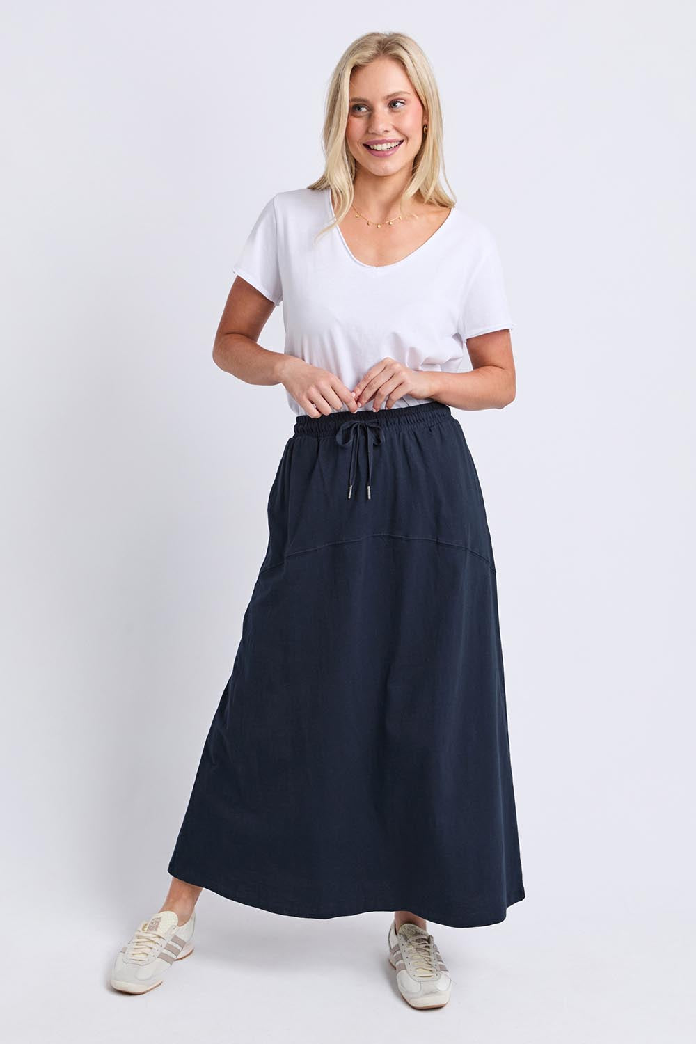 Model Genericm wearing size sample of the Fundamental Meadow Cotton Skirt – Navy in colour Navy, from the front