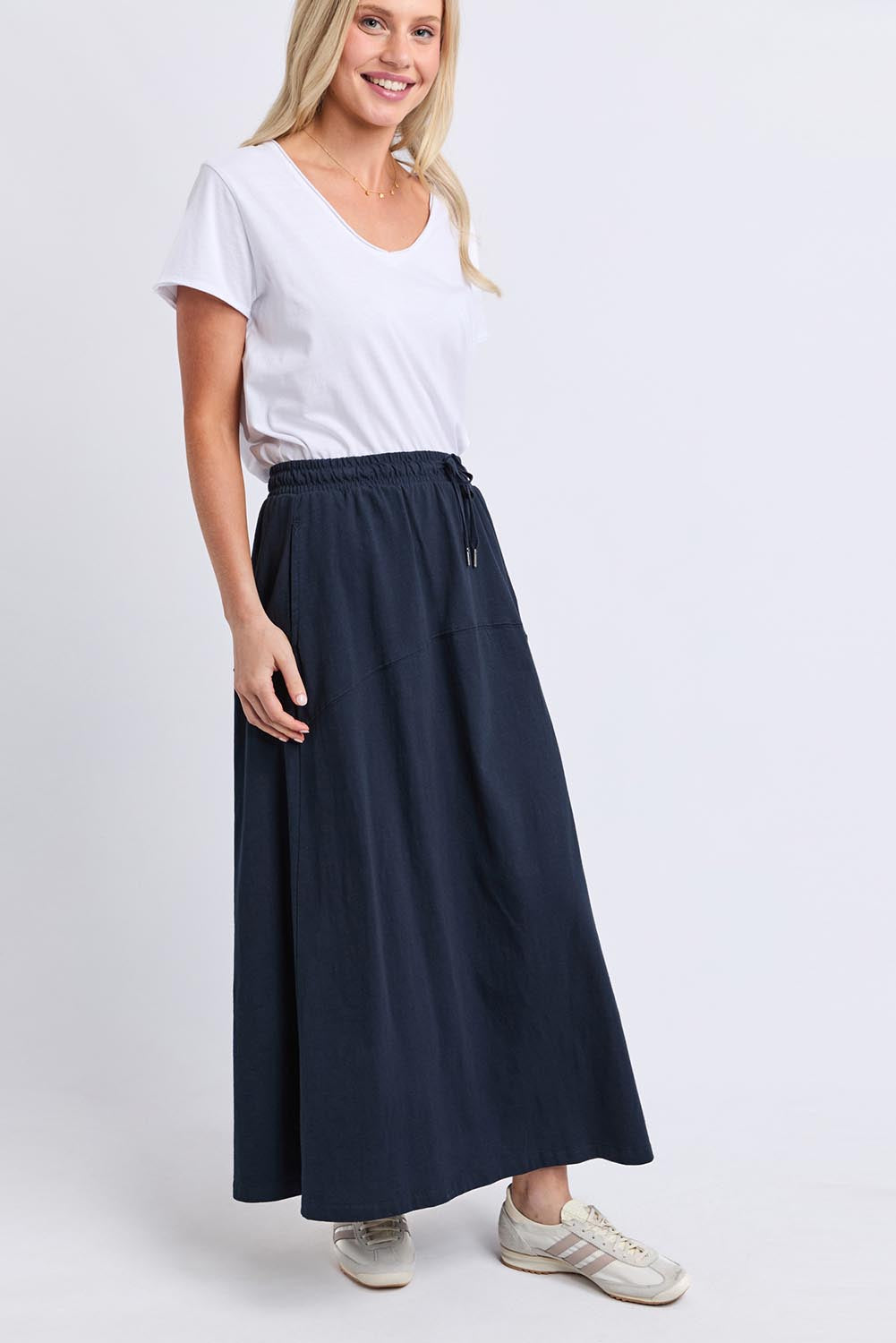 Model Genericm wearing size sample of the Fundamental Meadow Cotton Skirt – Navy in colour Navy, from the front