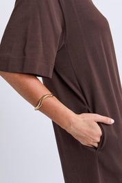 Model Genericm wearing size sample of the Fundamental Mish Cotton Dress – Coffee in colour Coffee, from an angle