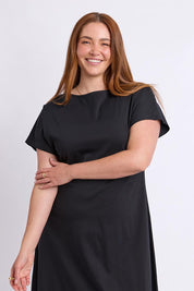 Model Genericm wearing size sample of the Fundamental Lottie Cotton Dress – Black in colour Black, in a cropped view