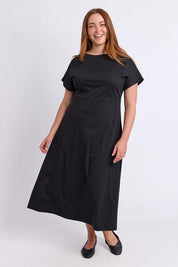 Model Genericm wearing size sample of the Fundamental Lottie Cotton Dress – Black in colour Black, from the front