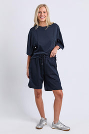 Model Genericm wearing size sample of the Fundamental Summer Fleece Cotton Short – Navy in colour Navy, from the front
