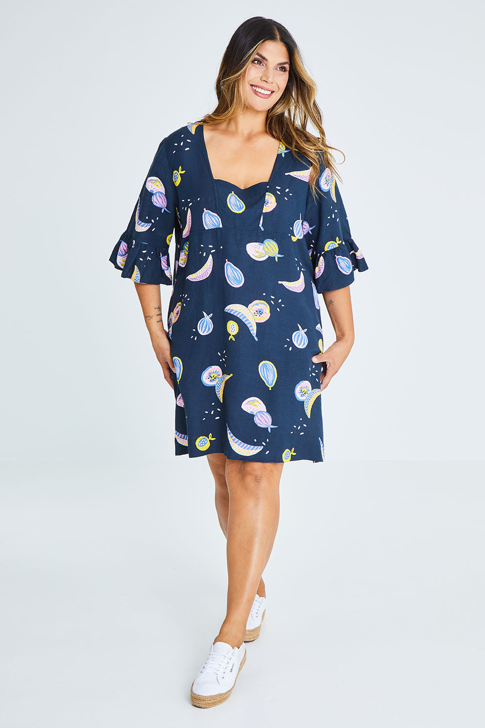 Model Palatina wearing size 16 of the Fruity Tootie Dress in colour Navymulti (Blue), from the front, showing the whole outfit