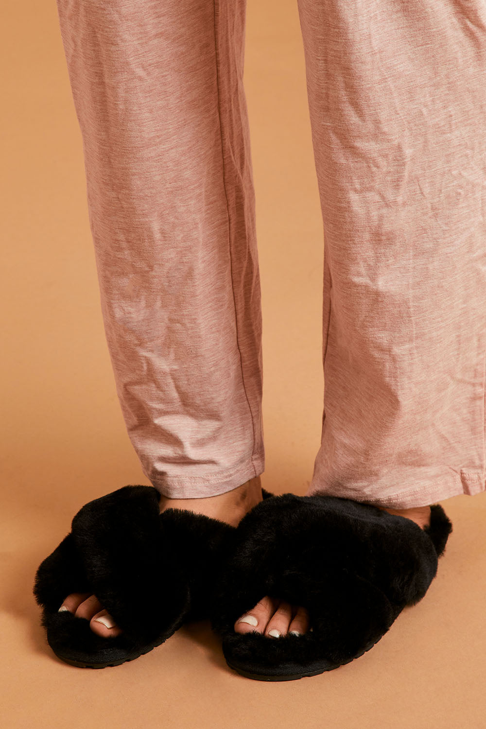 A model wearing size 8 of the Mayberry Slipper Slide in colour Black (Black), from the front, cropped image