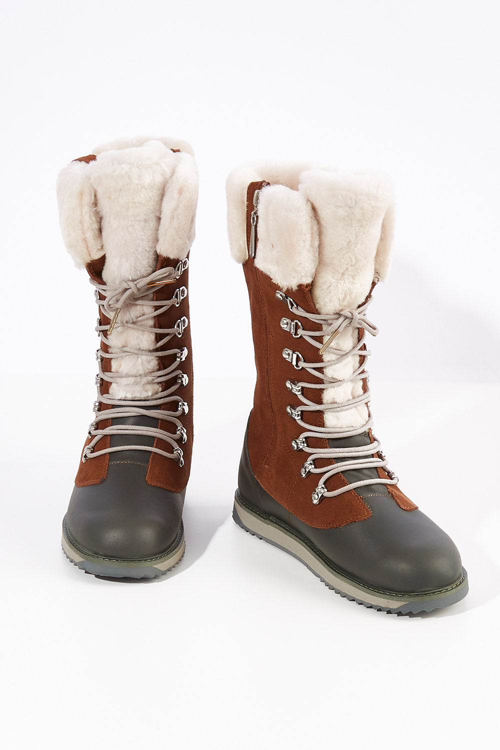 A model wearing size 7 of the Orica Hi Waterproof Leather Boot in colour Oak, from the front, showing the whole outfit