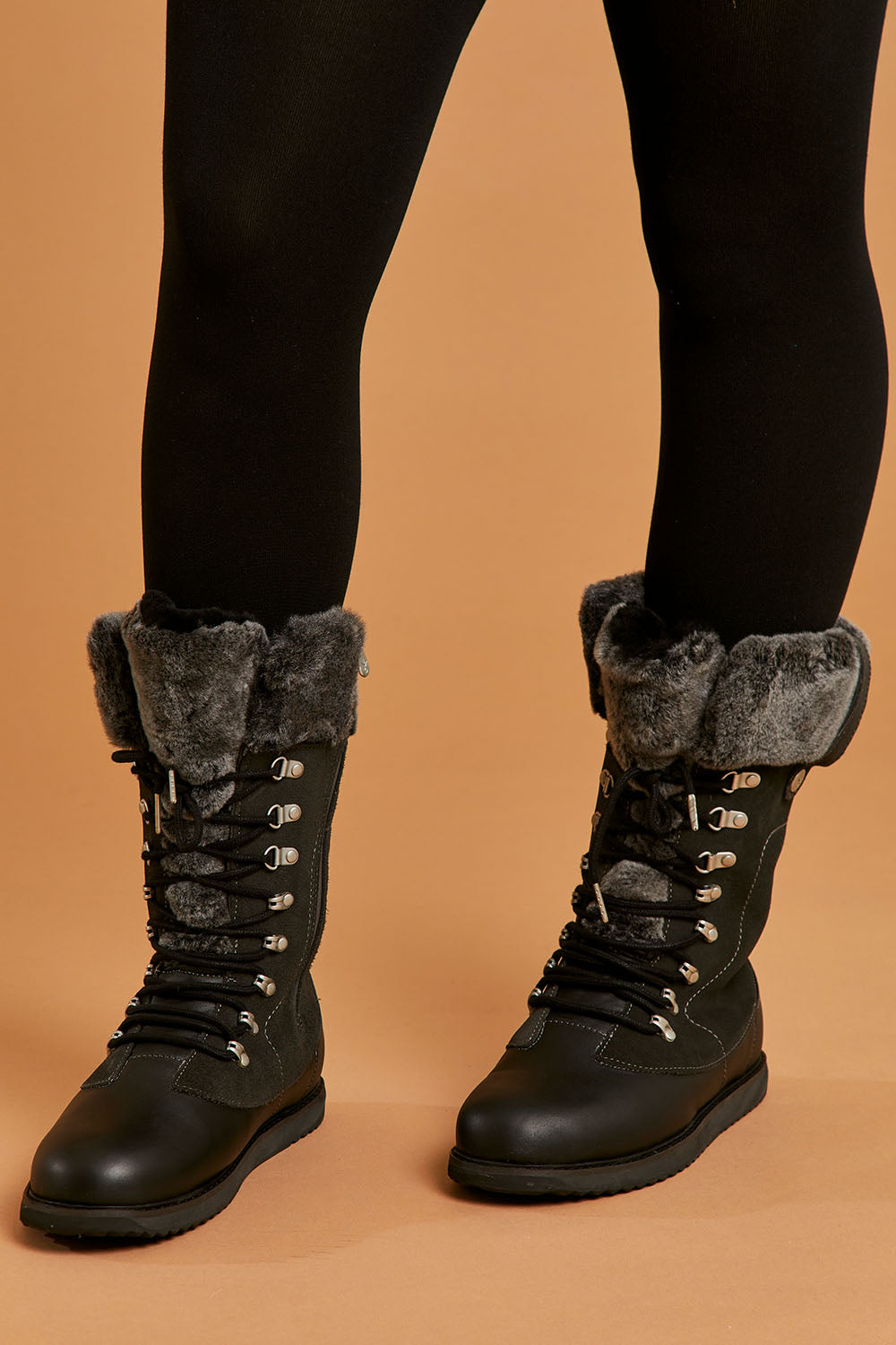 A model wearing size 8 of the Orica Hi Waterproof Leather Boot in colour Darkgrey (Grey), from the front, cropped image