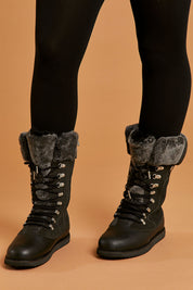 A model wearing size 8 of the Orica Hi Waterproof Leather Boot in colour Darkgrey (Grey), from the front, cropped image