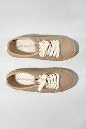 A model wearing size 7 of the Agonis Organic Sneaker in colour Almond, from the front, showing the whole outfit