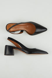 A model wearing size 37 of the Aura Leather Heel in colour Black (Black), from the front, showing the whole outfit