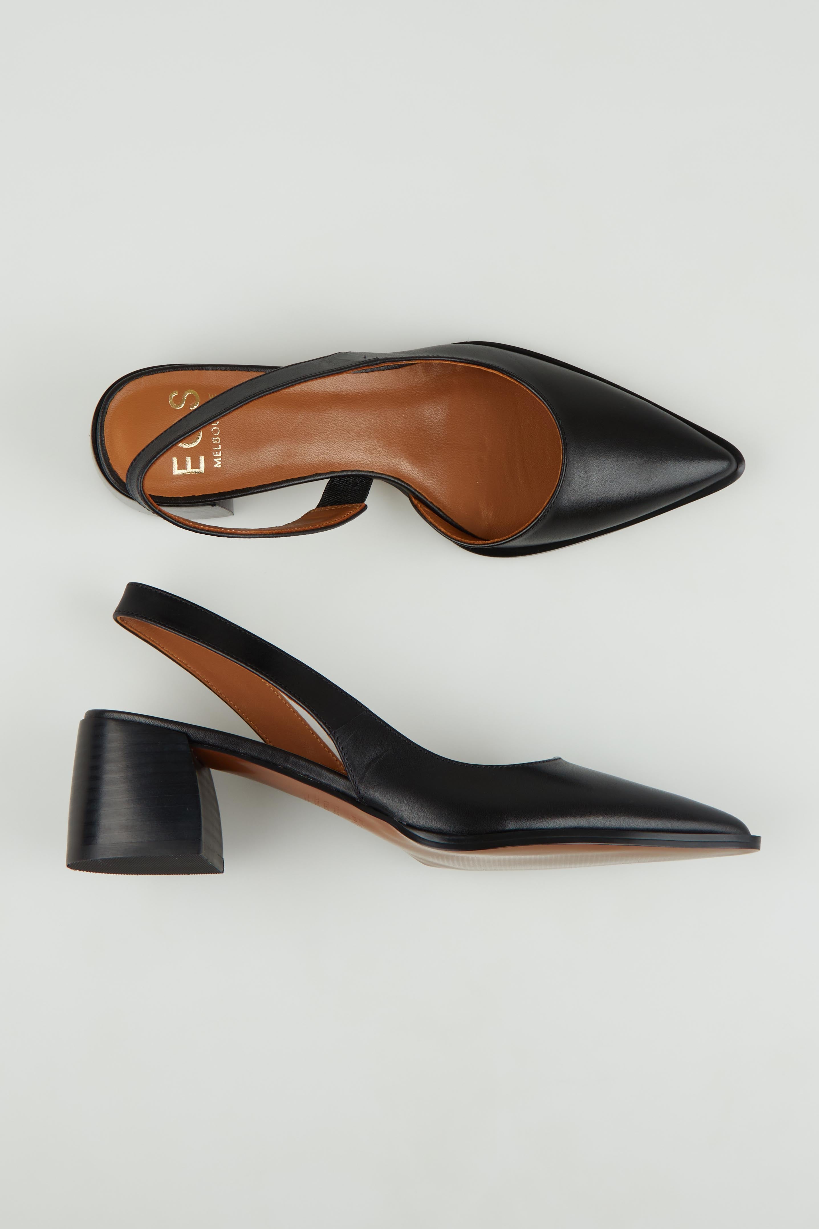 A model wearing size 37 of the Aura Leather Heel in colour Black (Black), from the front, showing the whole outfit