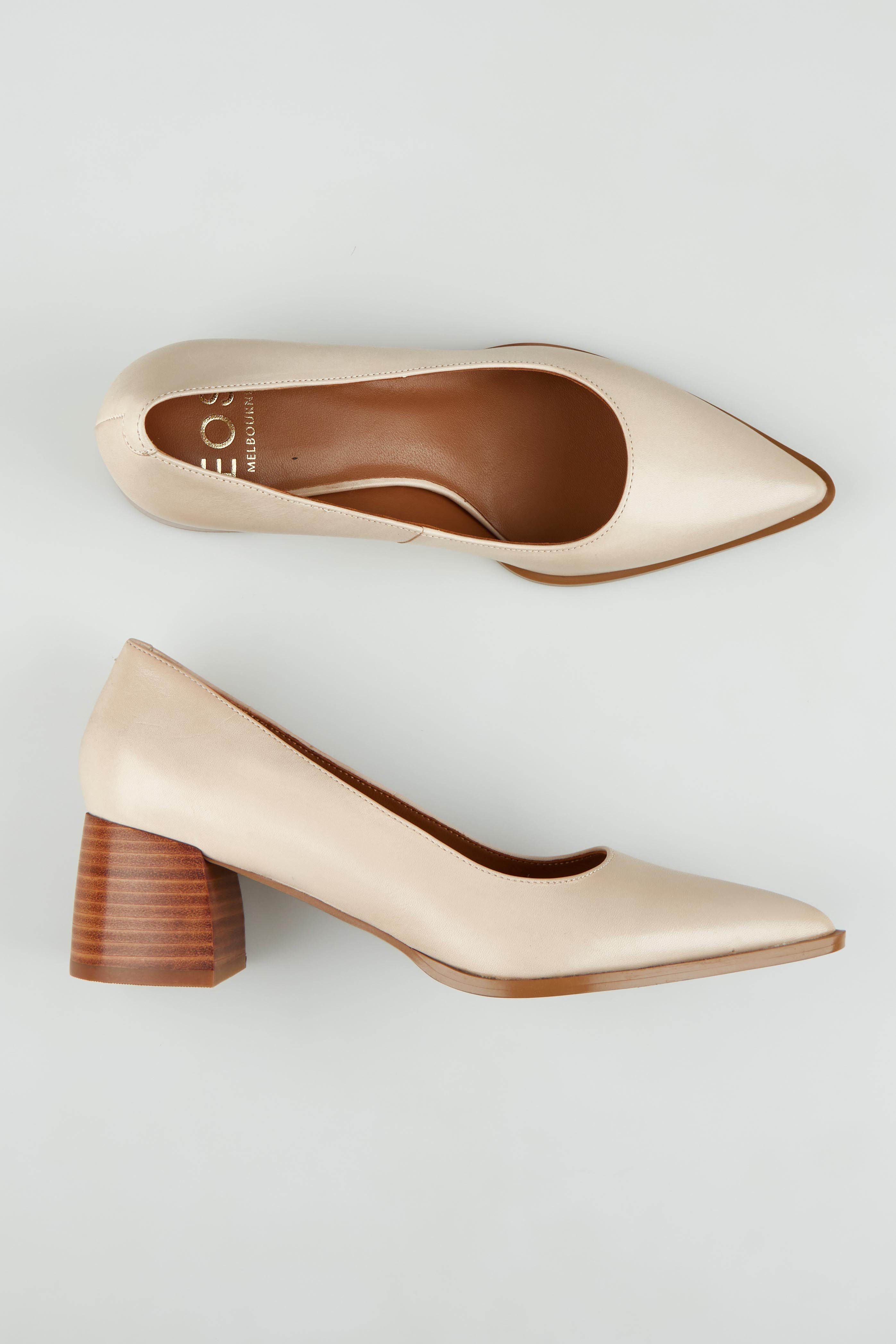 A model wearing size 37 of the Auris Leather Heel in colour Nude, from the front, showing the whole outfit