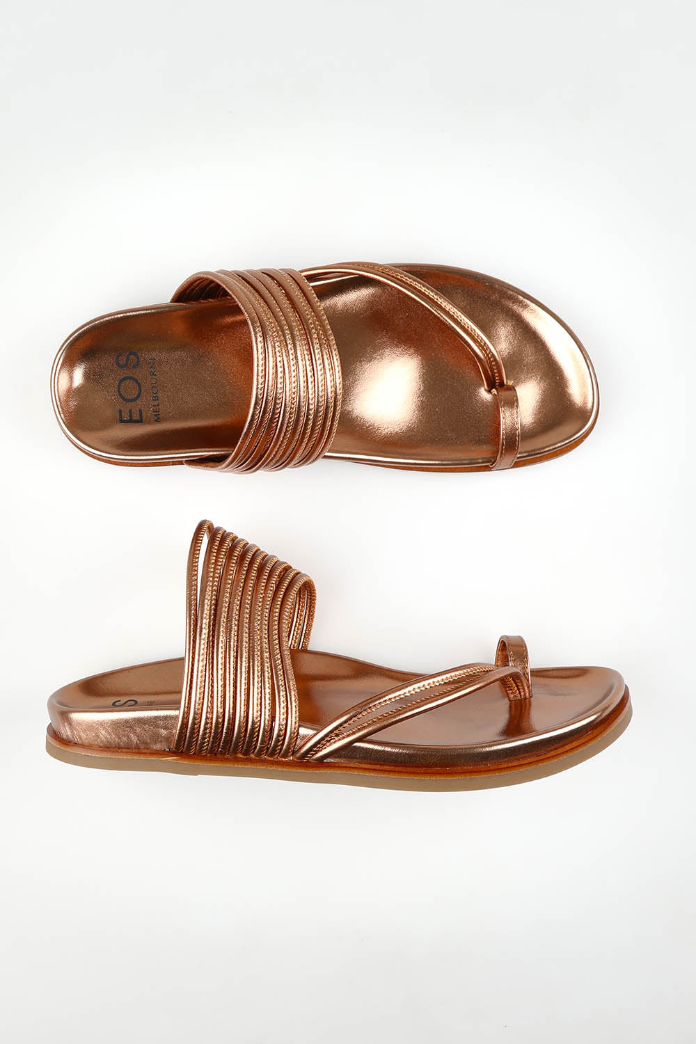A model wearing size 37 of the Carmella Leather Slide in colour Copper (Metallics), from the front, showing the whole outfit