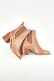 A model wearing size 37 of the Chai Leather Ankle Boot in colour Latte, from the front, showing the whole outfit