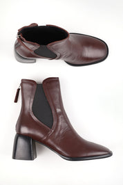 A model wearing size 37 of the Charlie Leather Ankle Boot in colour Chestnut, from the front, showing the whole outfit