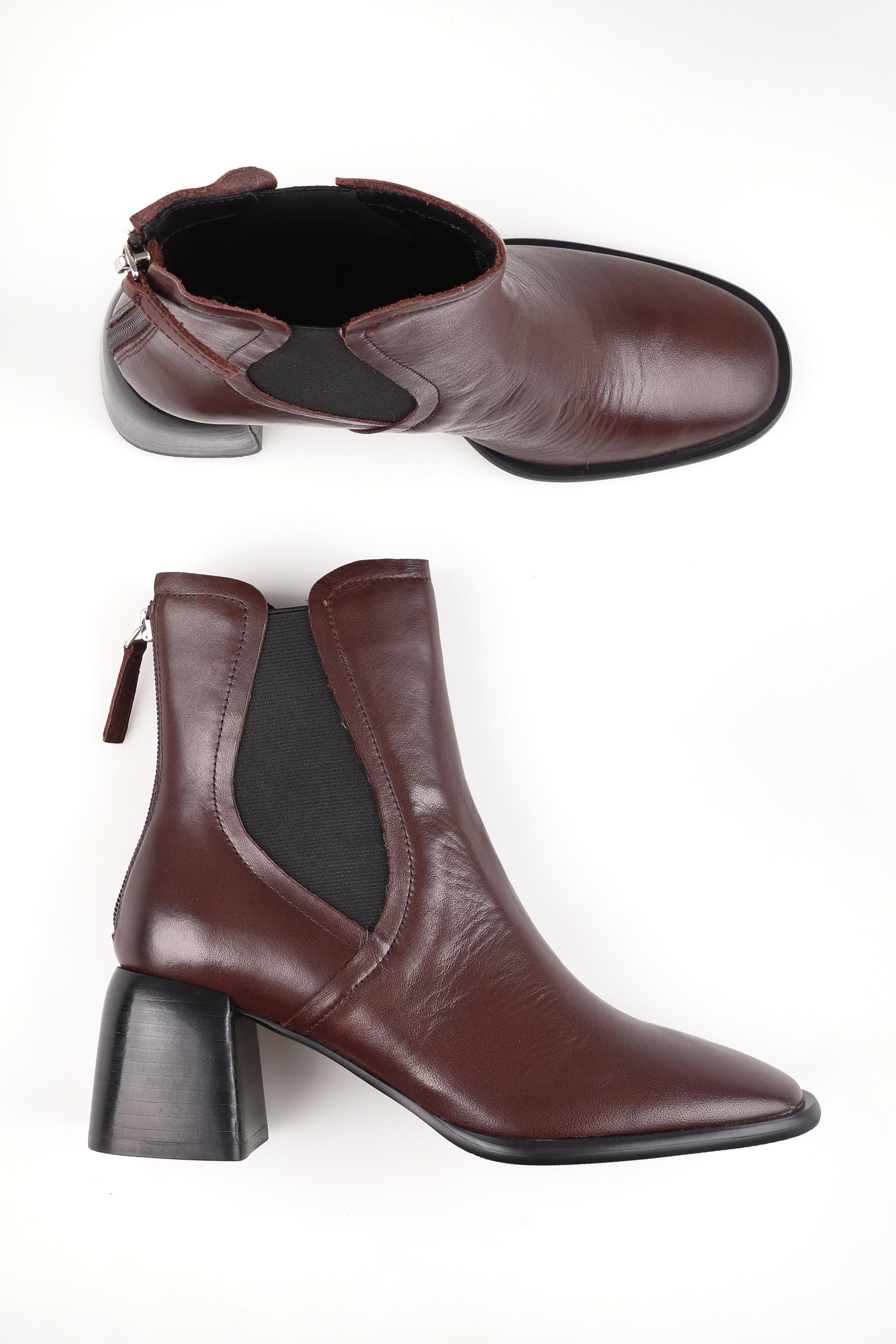 A model wearing size 37 of the Charlie Leather Ankle Boot in colour Chestnut, from the front, showing the whole outfit