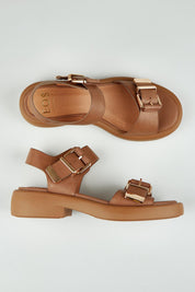 A model wearing size 37 of the Ele Leather Flat in colour Pecan, from the front, showing the whole outfit
