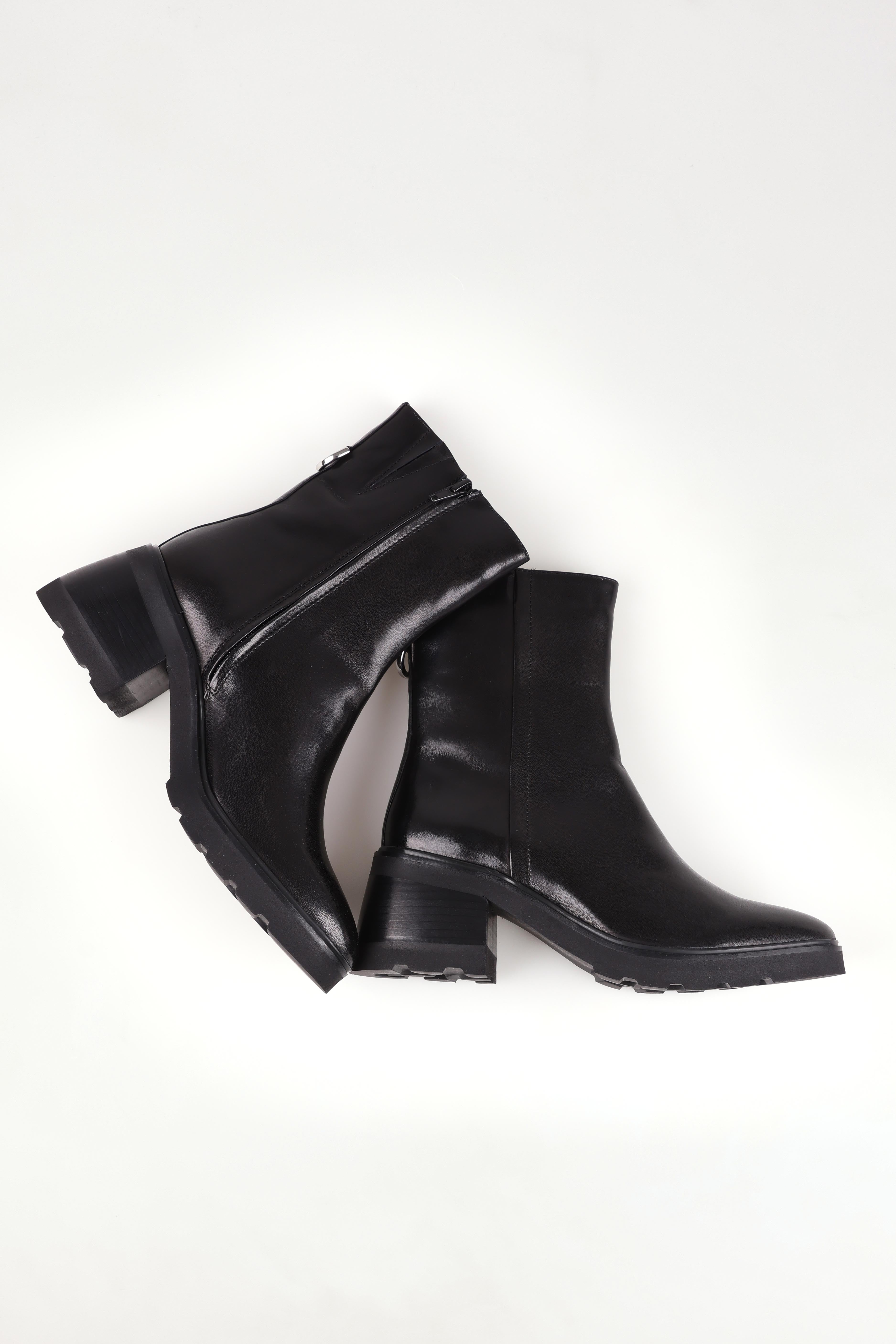 A model wearing size 37 of the Finley Leather Ankle Boot in colour Black (Black), from the front, showing the whole outfit