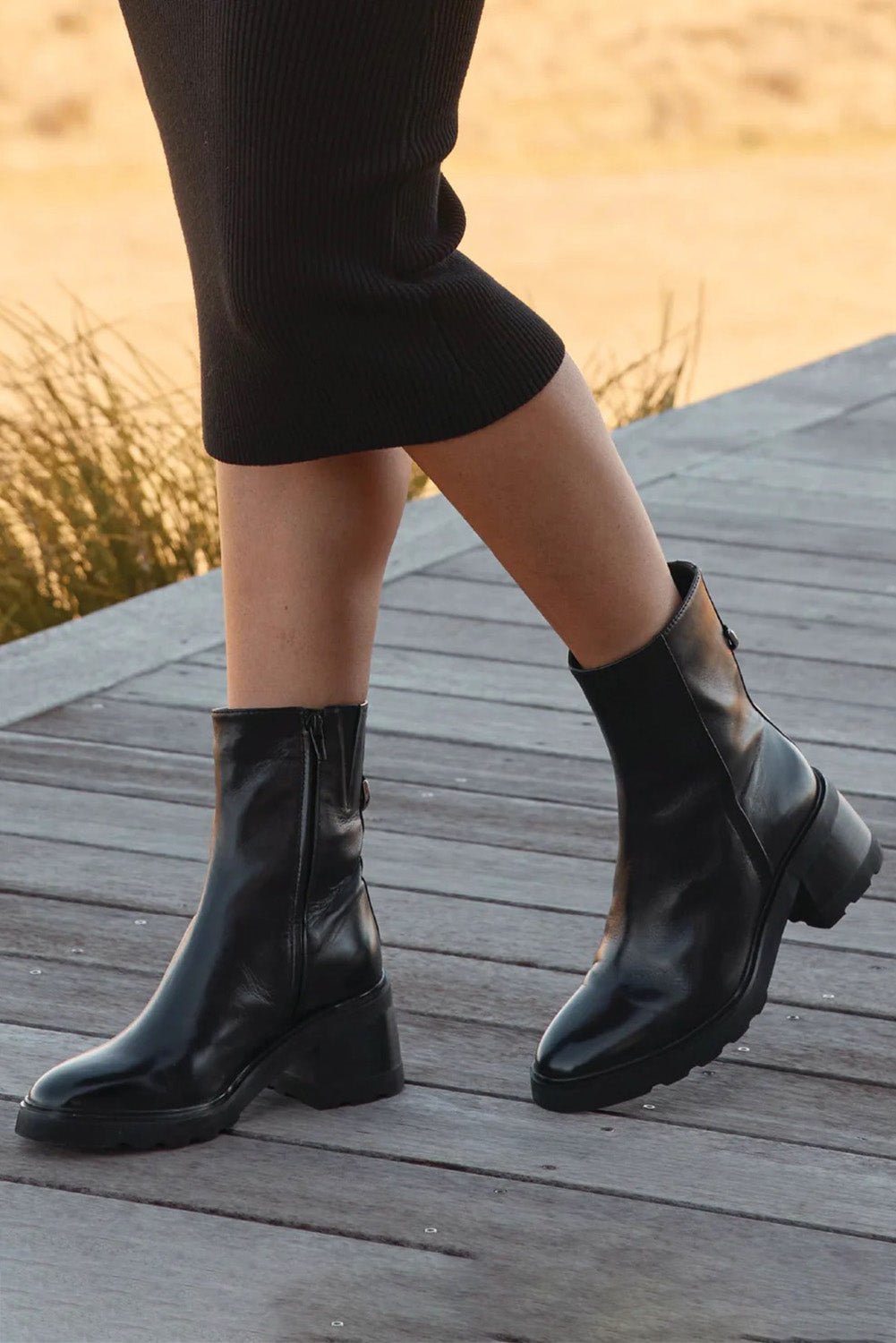 A model wearing the Finley Leather Ankle Boot in colour Black (Black), from the front, showing the whole outfit