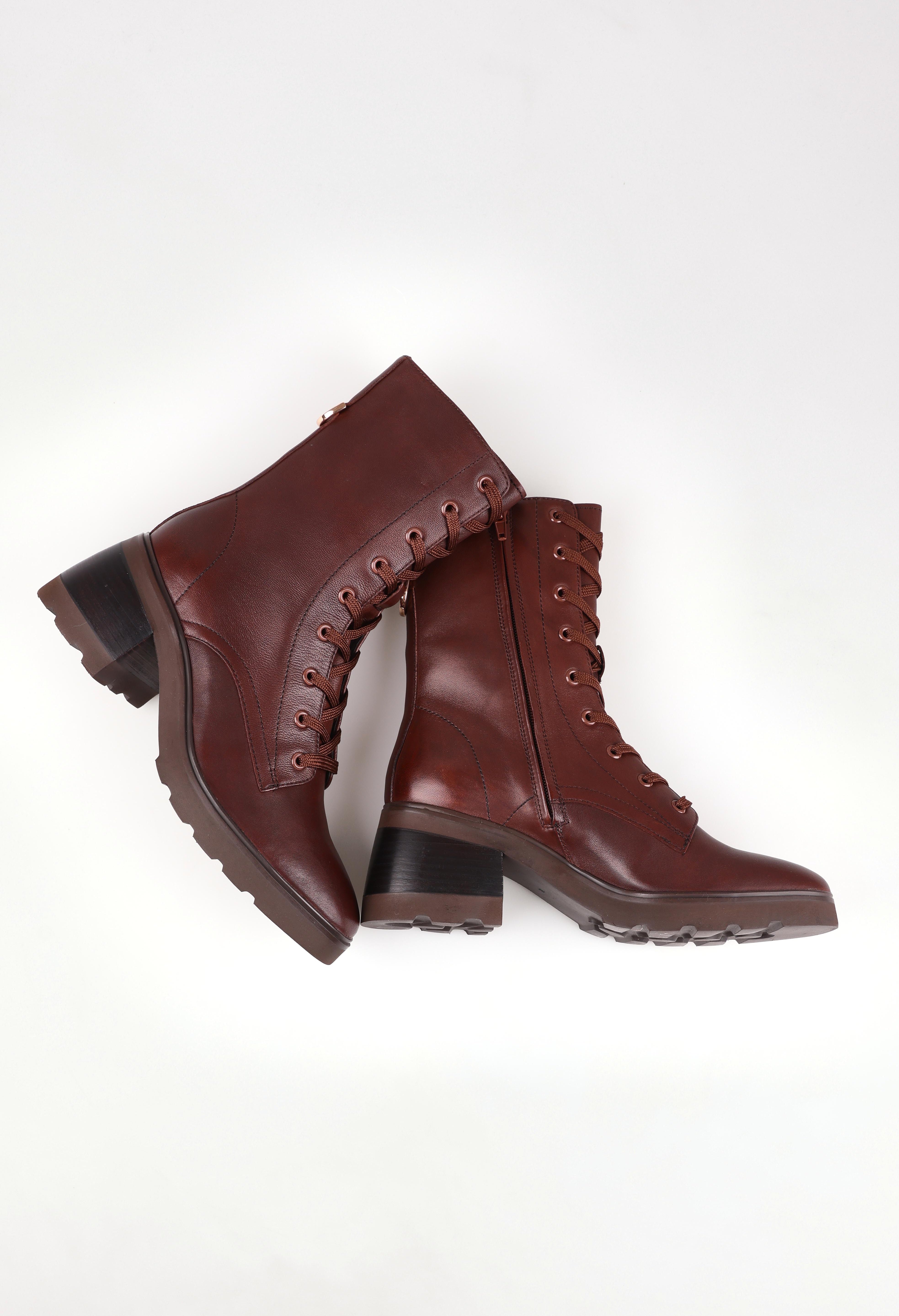 A model wearing size 37 of the Finton Lace Up Boot in colour Redwood, from the front, showing the whole outfit