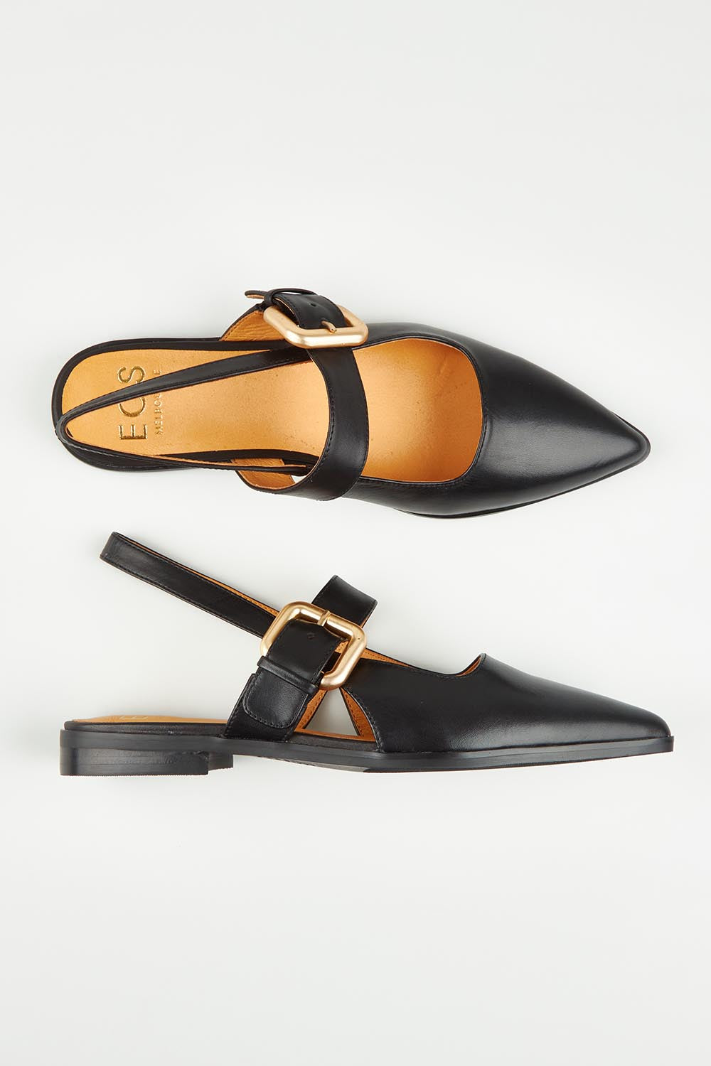A model wearing size 37 of the Goldie Leather Flat in colour Black (Black), from the front, showing the whole outfit