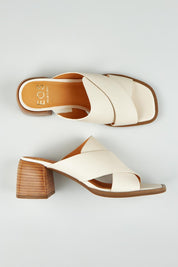 A model wearing size 37 of the Iso Leather Heel in colour Bone, from the front, showing the whole outfit