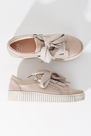 A model wearing size 36 of the Jovi Leather Sneaker in colour Stone (Grey), from the front, showing the whole outfit
