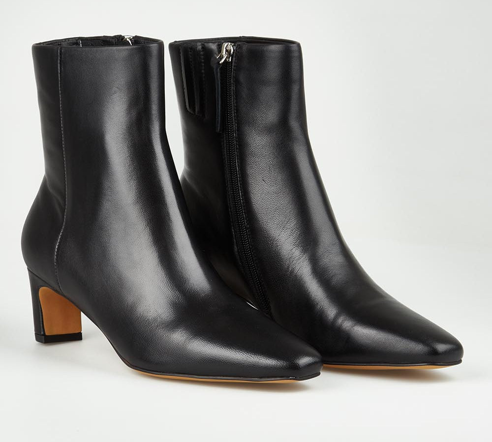 A model wearing size 37 of the Kitan Leather Ankle Boot in colour Black (Black), from the front, showing the whole outfit