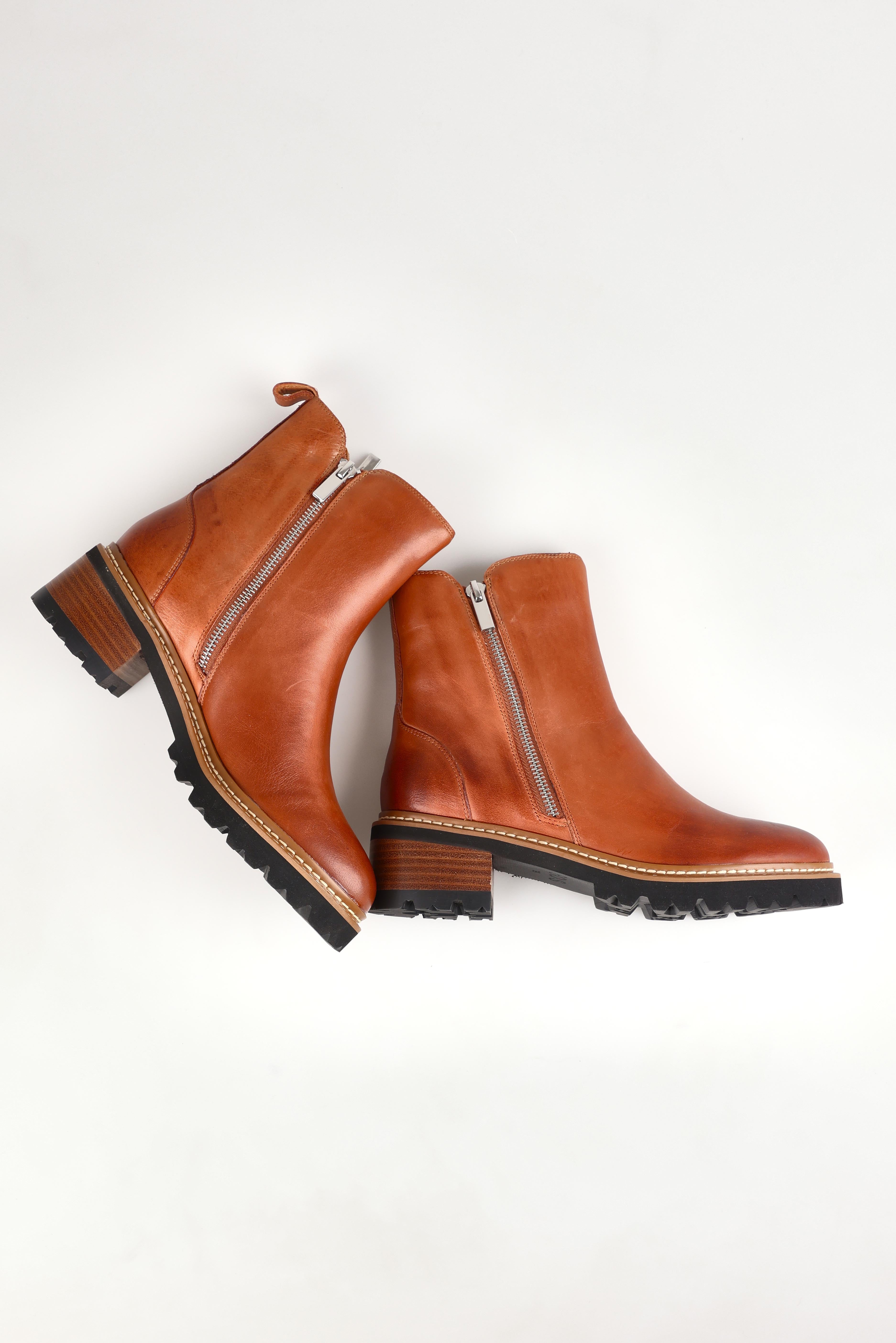 A model wearing size 37 of the Lindira Double Zip Leather Ankle Boot in colour Brandy, from the front, showing the whole outfit