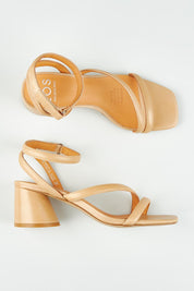 A model wearing size 37 of the Petricia Leather Heel in colour Nude, from the front, showing the whole outfit
