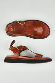 A model wearing size 37 of the Slays Leather Sandal in colour Brandy, from the front, showing the whole outfit