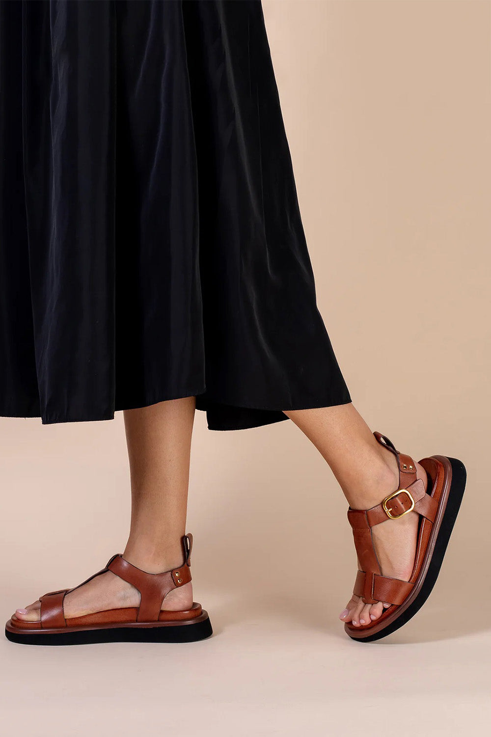 A model wearing the Slays Leather Sandal in colour Brandy, from the front, showing the whole outfit