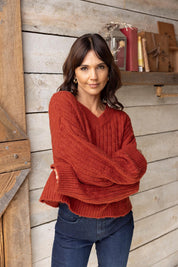 A model wearing the Knit V Neck Jumper in colour Rust, from the front, showing the whole outfit